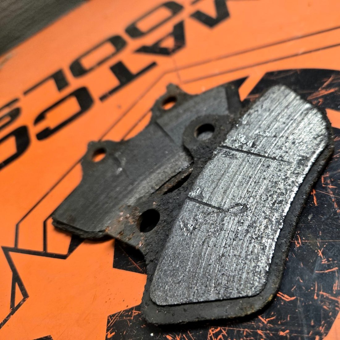 Worn motorcycle brake pads removed at Blackwood Cycles in Walden, New York.
