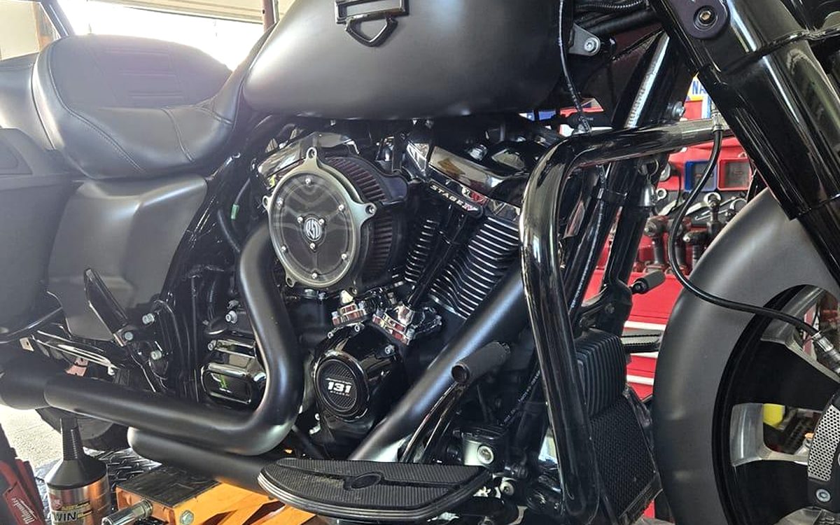 A Harley-Davidson Stage IV engine on the lift at Blackwood Cycles, chrome air cleaner and blacked-out cylinder fins in view